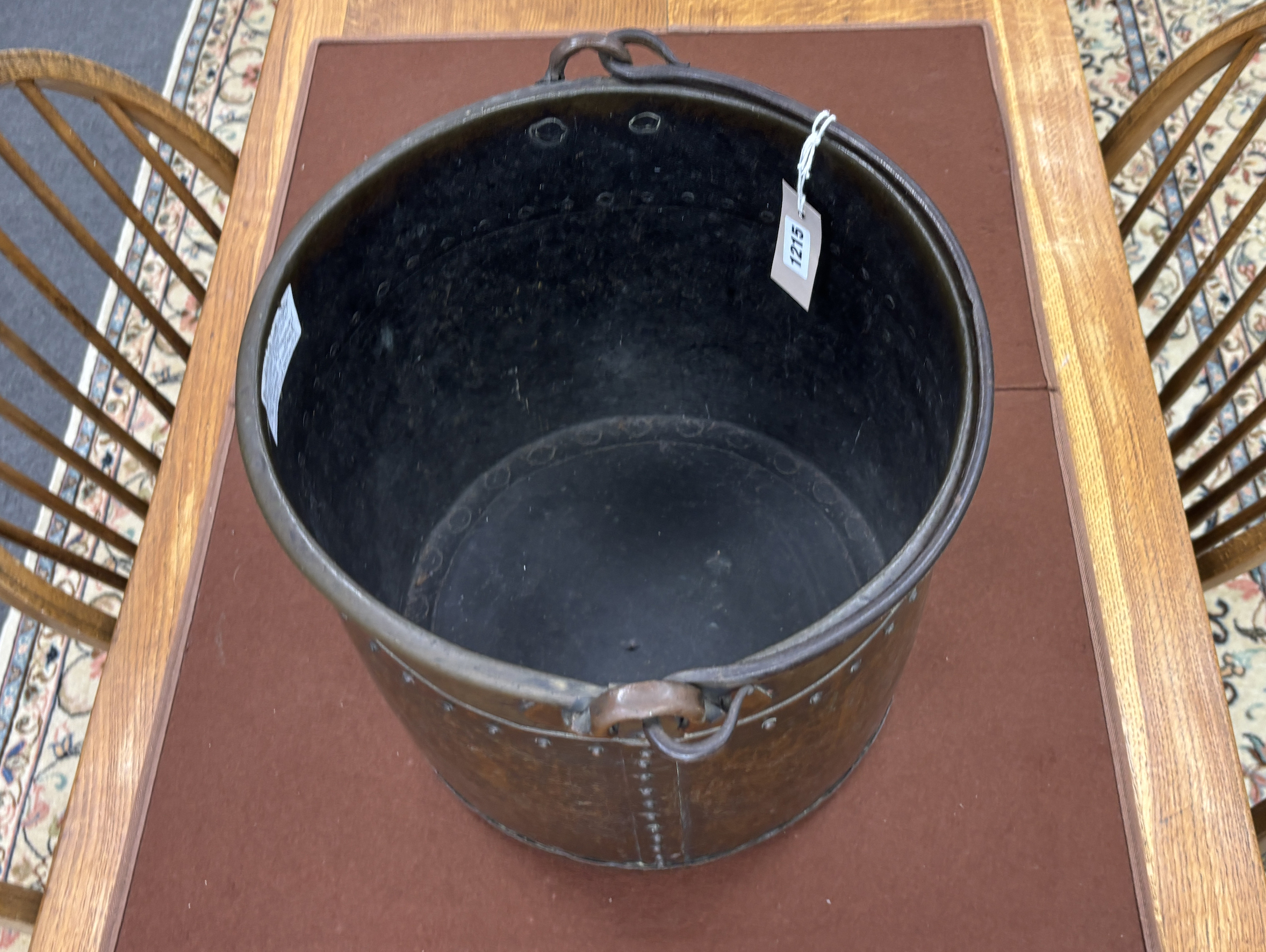 A late Victorian Arts and Crafts hammered copper coal bucket with iron swing handle, diameter 34cm, height 31cm.